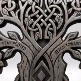 Engraved Celtic tree crown with the words Stay Rooted and Reach Toward the Sky, close-up