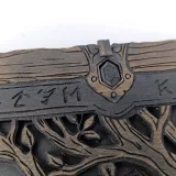 Rune-carved wall and tree branches of the backgammon lid, close-up